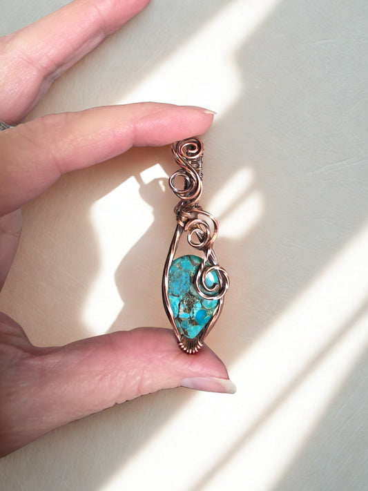Handcrafted genuine Turquoise/ copper wire wrapped pendant.